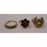 A 9 carat gold horsehead in a horseshoe ring, together with a 9 carat gold garnet cluster ring,