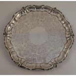 A Victorian silver salver, with shaped ogee border, the centre engraved with scrolling leaves,