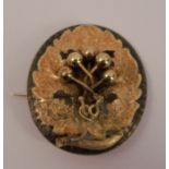 A Victorian gold brooch, the oval frame with a leaf and berry centre, 4.6cm long, 12g gross