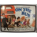 A framed On the Buses film poster, 29.5ins x 39.5ins