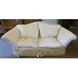 A two seater settee, in gold flower scroll fabric, with serpentine back, width 76.5ins