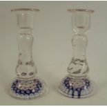 A pair of glass candlesticks, with clear glass stem and baluster wrythen sconce, raised on a