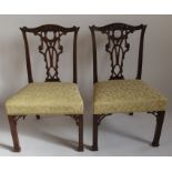 A set of 6 Chippendale style mahogany dining chairs, having an ornate pierced back with carved