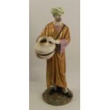 A 19th century Royal Worcester figure of an Eastern water carrier, stamped Hadley to the base, a man