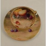 A Royal Worcester miniature tea cup and saucer, decorated with hand painted fruit by Harper and