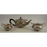 A silver three piece tea set, with gadrooned rim and lower body, Birmingham 1927, maker Alexandra