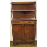 A late Regency chiffonier, with two tiered shelves over a fitted frieze drawer, with cotton reel