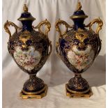 A pair of Royal Worcester covered vases on pedestals, decorated with a rich blue and gilt ground,