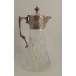 A glass and silver plated mounted claret jug, the silver plated mount decorated with flowers and