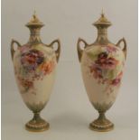 A pair of Royal Worcester gilded ivory covered vases, decorated with flowers, shape number 1921,