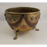 A brass jardiniere, with lions mask and ring handles, having applied copper stars and crescents,