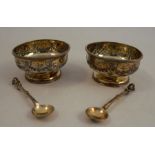 A pair of Victorian silver gilt pedestal salts, decorated with garlands, together with matching salt