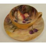 A Royal Worcester coffee cup and saucer, decorated with fruit by Roberts and Phillips, circa 1922