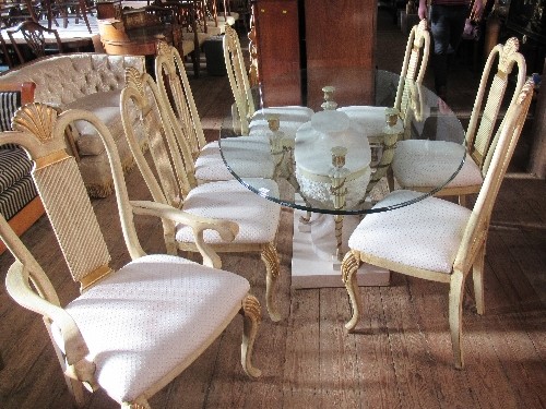 A modern dining/conservatory suite, in the Egyptian style, the dining table with oval glass top,