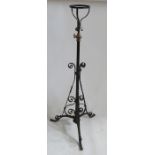 A wrought iron adjustable oil lamp stand, with scroll decoration, height 52ins