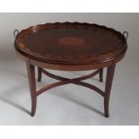 An Edwardian style oval tray table, the lift out tray with brass handles, satinwood border and a