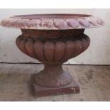 A metal campana shaped garden urn, raised on a square base, diameter 19.5ins x height 14.5ins,