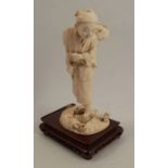 A 19th century carved ivory model, of an Eastern man carrying a child on his back, signed, af,