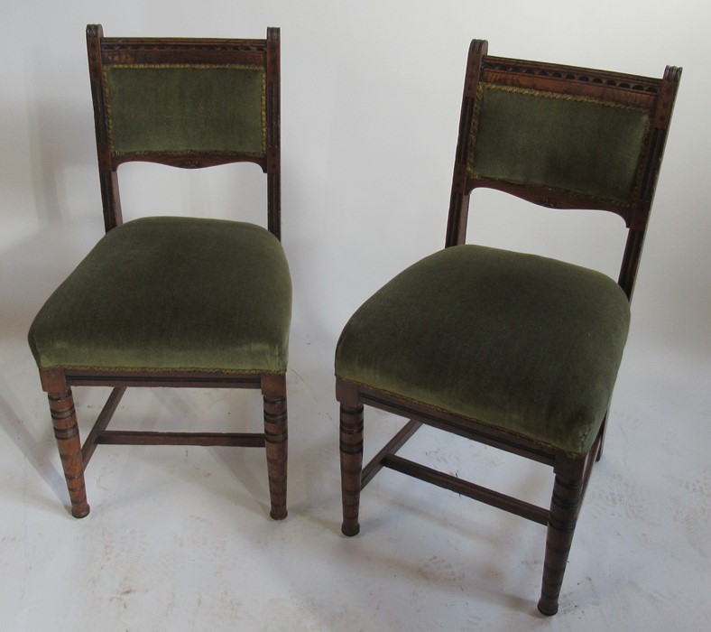 A set of six Edwardian oak dining chairs, with moulded sides, and cotton reel turned legs united