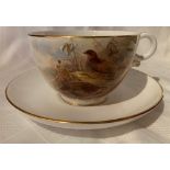 A Royal Worcester breakfast, or over-sized, cup and saucer decorated with quail by Jaz Stinton,