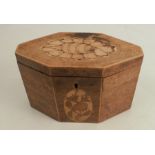 A 19th century mahogany tea caddy, of elongated octagonal form, inlaid with a shell to the top and a