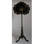 A 19th century papier mache and ebonised wood pole screen, having a mother of pearl inlaid panel and