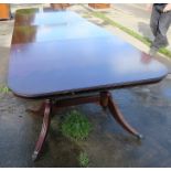 A modern reproduction mahogany veneered dining table, raised on pillars, width 48ins, length 167ins,