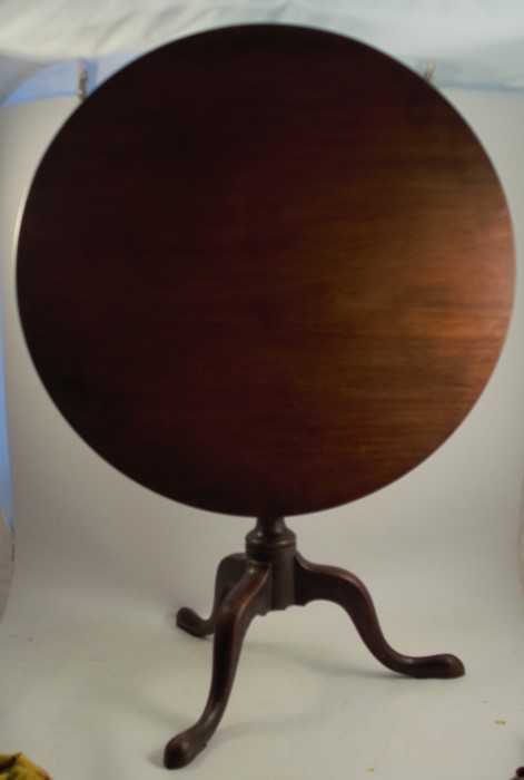 A late Georgian mahogany occasional table, with circular top, raised on a turned wrythen moulded