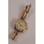 Rolex, a lady's 9 carat gold mechanical wrist watch, the unsigned circular white dial with gilt