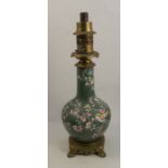 An oriental vase, decorated with birds and prunus to a green round, converted to an oil lamp, height