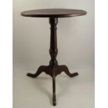 A 19th century primitive oak circular occasional table, raised on turned column terminating in a
