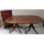 A mahogany regency style dining table, raised on pillars with one leaf, length without leaf 67ins,