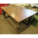 An Antique style oak refectory table, the rectangular top set with an inkwell, raised on heavily
