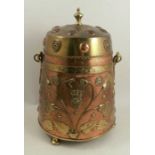 An Arts and Crafts style brass and copper covered coal bucket, decorated with lions masks and