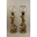 A pair of Royal Worcester blush ivory table lamps, in the Kate Greenaway style, decorated with