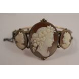 A cameo set hinged bangle, the three graduated cameos carved as classical female profiles, 18.7g