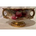 A Royal Worcester bowl, on a foot, having two handles and scalloped shaped rim, decorated with roses