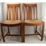 A pair of rush seated Heals dining chairs, with circular plastic disc stamp to the rearCondition