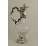 A modern silver mounted and glass claret jug, the mounts embossed with scrolls and flowers, height