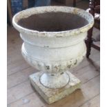 A Campagna style cast iron garden urn, raised on a square pedestal, height 24ins x approximate width