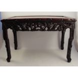 A Chinese rectangular hardwood opium table, having a pierced frieze, and raised on carved legs, 29.