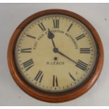 A 19th century mahogany framed circular wall clock, the dial inscribed East Ham Education
