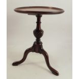 An antique miniature mahogany tripod table, having a dished top and a spirally fluted baluster stem,