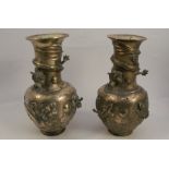 A pair of brass vases, decorated all around in relief with an applied dragon, character mark to
