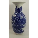An oriental blue and white vase, of baluster form, decorated with figures and pagodas in a