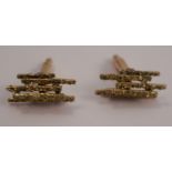 A pair of 1970's cufflinks, stamped 14k, composed of textured batons, 13.8g gross