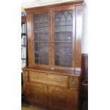 A 19th century mahogany secretaire bookcase, having glazed doors over opening to reveal shelves,