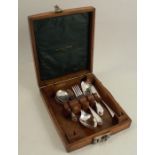 An early 20th century silver plated part set of cutlery, in an oak carry case, the lid interior