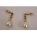 A pair of cultured pearl and diamond drop earrings, the oval cultured pearl of approximately 90mm by