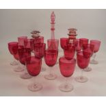 A collection of 16 various cranberry wine glasses, raised on clear stems and circular foots,